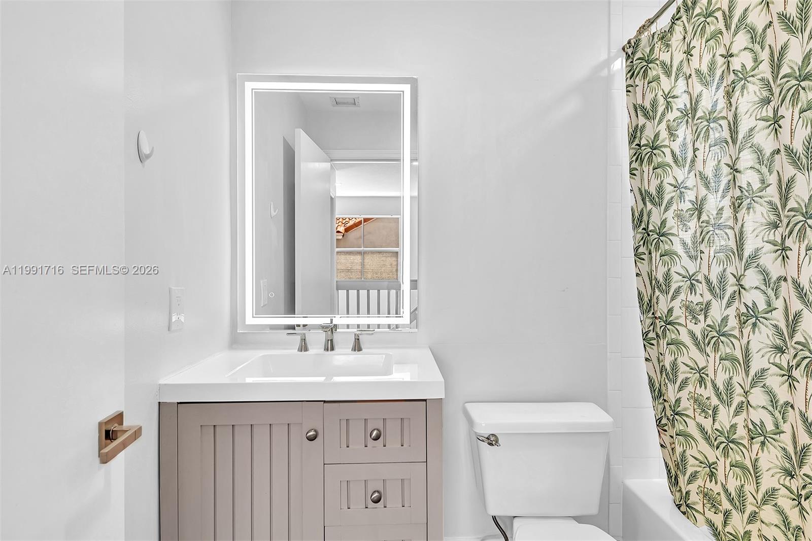 3085 North 36th Avenue Hollywood, FL 33021 - Photo 36 of 76 a bathroom with a sink a toilet and a mirror