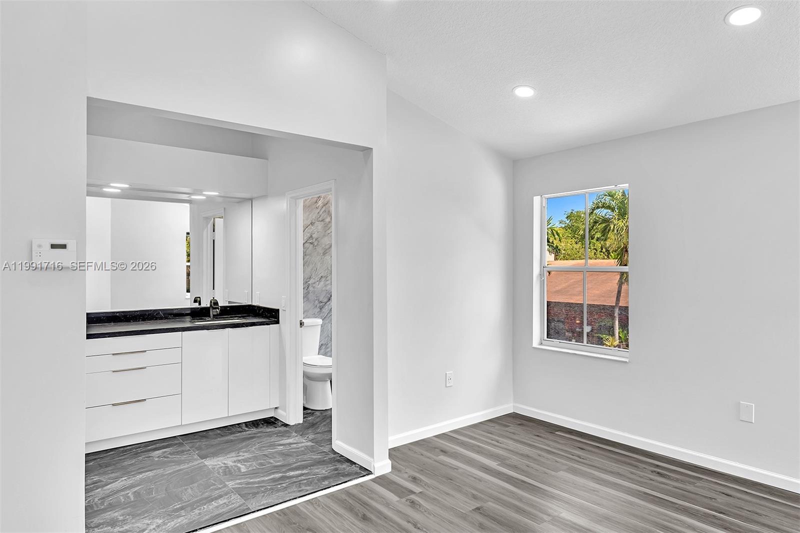 3085 North 36th Avenue Hollywood, FL 33021 - Photo 39 of 76 a kitchen with granite countertop a stove a sink and a window