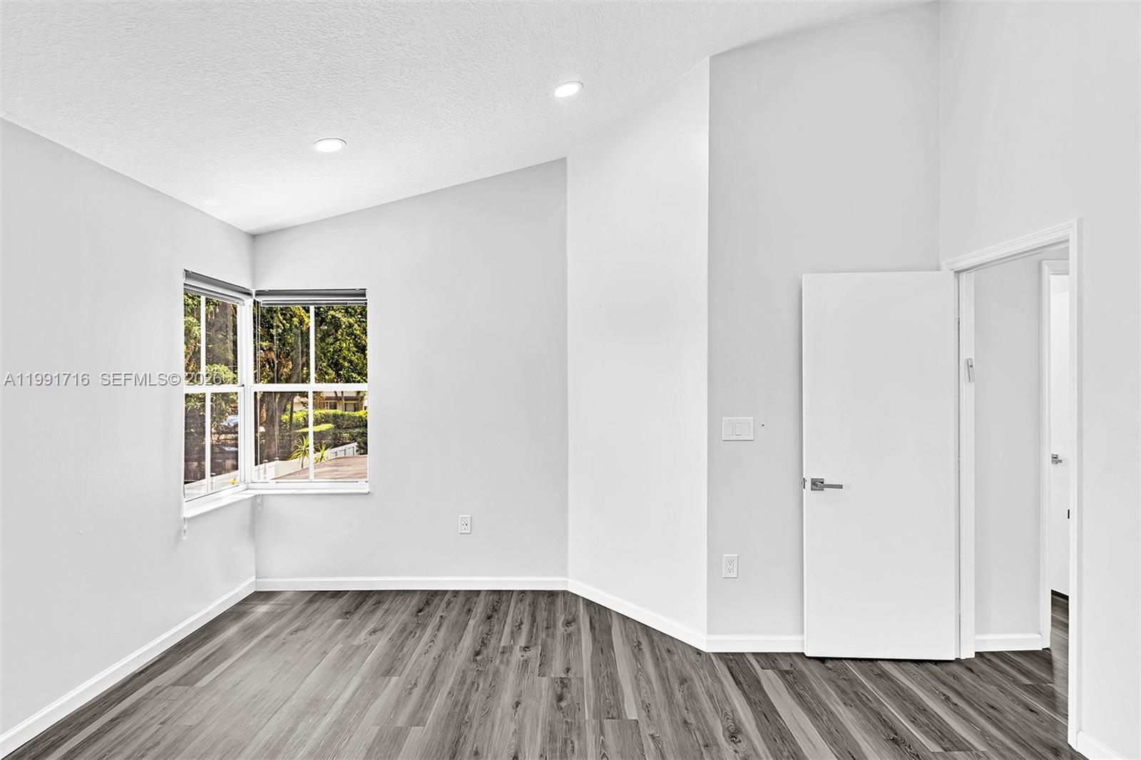 3085 North 36th Avenue Hollywood, FL 33021 - Photo 40 of 76 an empty room with wooden floor and windows
