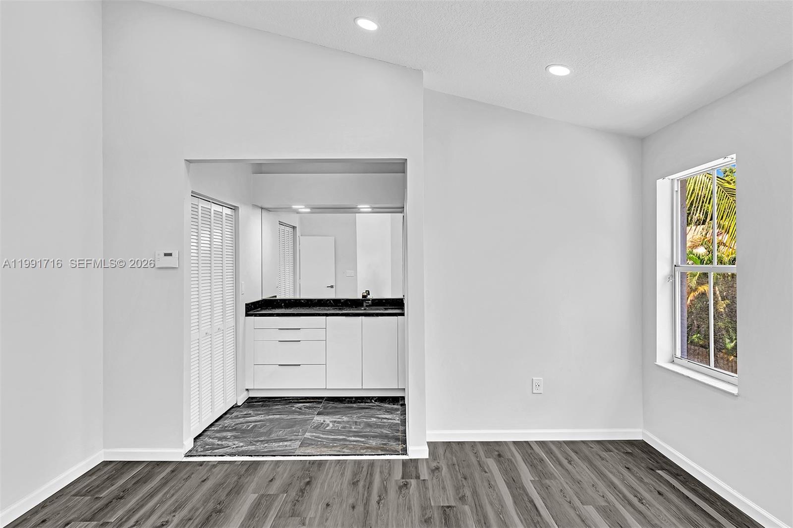3085 North 36th Avenue Hollywood, FL 33021 - Photo 42 of 76 a view of an empty room with window and wooden floor