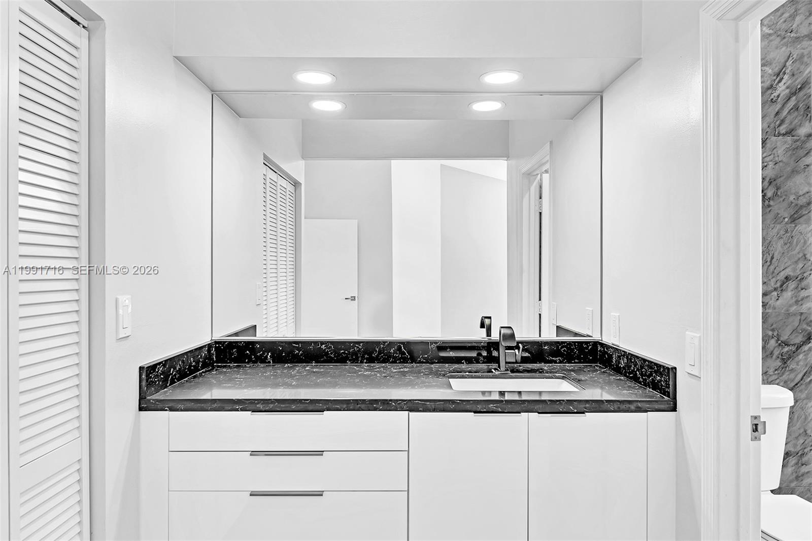 3085 North 36th Avenue Hollywood, FL 33021 - Photo 43 of 76 a bathroom with a granite countertop sink and a mirror