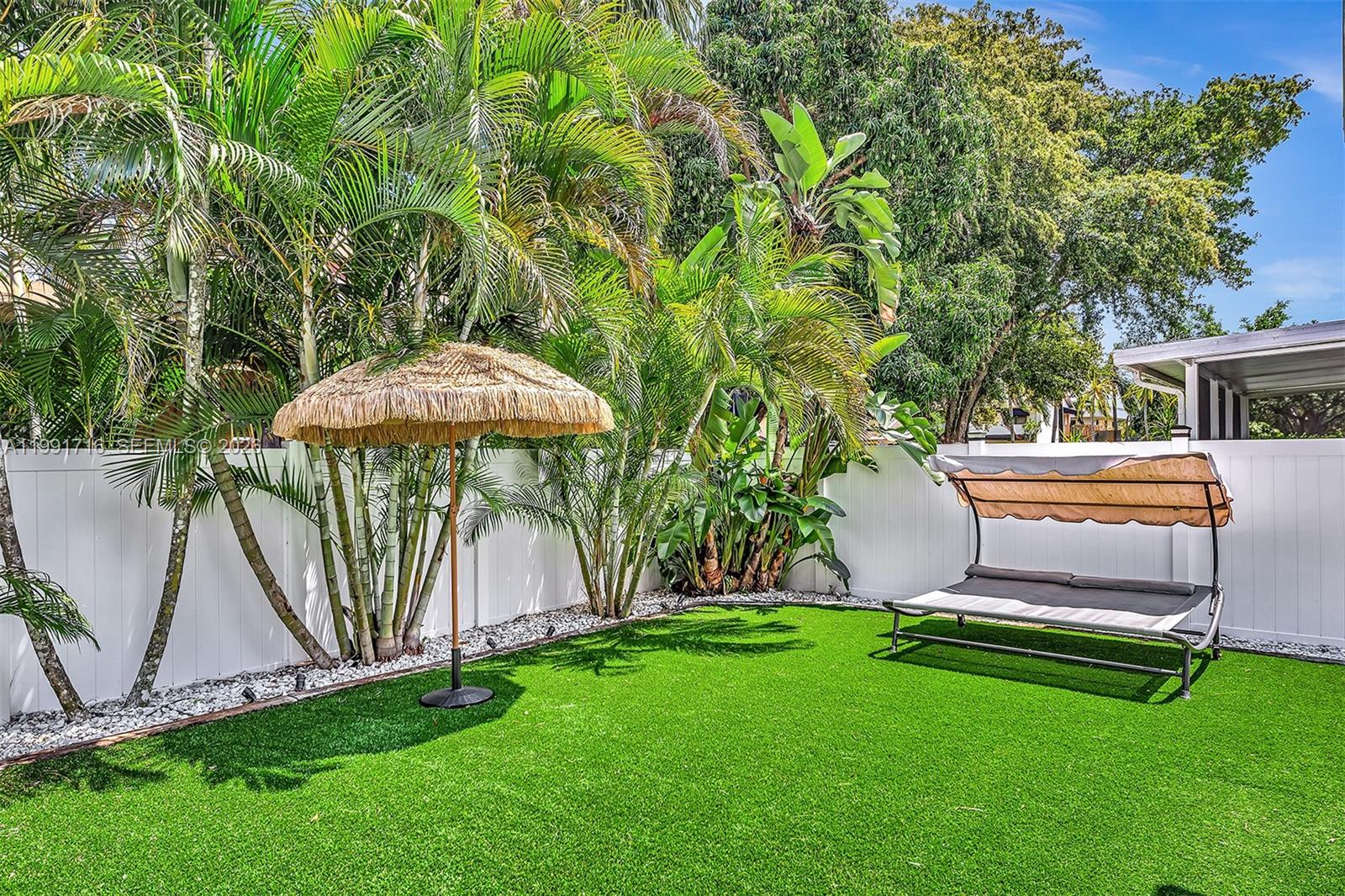 3085 North 36th Avenue Hollywood, FL 33021 - Photo 59 of 76 a backyard of a house with table and chairs