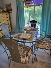 a view of a dining room with furniture and window