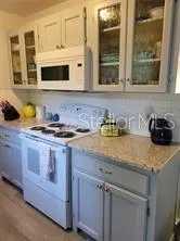 a kitchen with stainless steel appliances granite countertop a sink and a microwave
