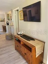 a living room with stainless steel appliances kitchen island granite countertop a stove and a sink