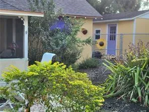 a backyard of a house with outdoor seating and plants