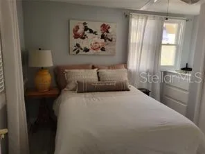 a bedroom with a bed and a window