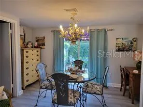 a view of a dining room with furniture and chandelier
