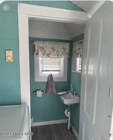 a bathroom with a sink a toilet and mirror
