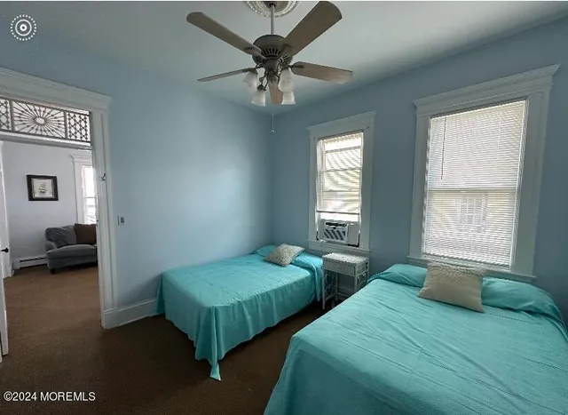 a bedroom with two beds and a large window