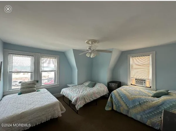 a bedroom with two beds and a window