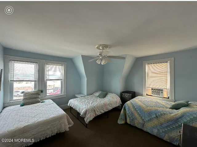 a bedroom with two beds and a window