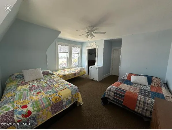 a bedroom with two beds and painted walls