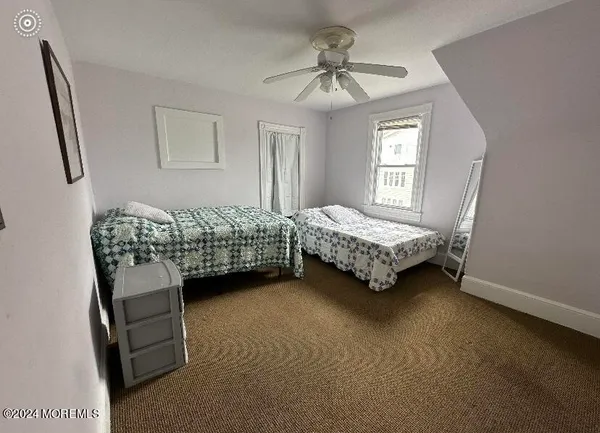 a living room with a bed furniture and a window