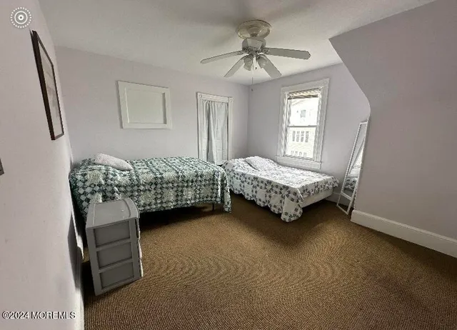 a living room with a bed furniture and a window