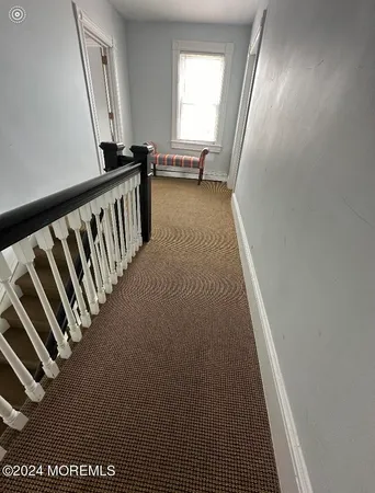 a view of a hallway with windows