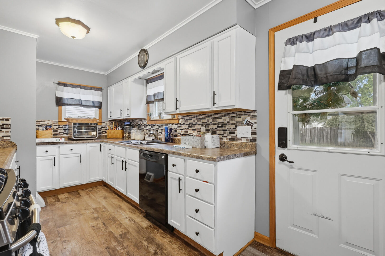 2224 41st Street Rock Island, IL 61201 - Photo 8 of 25 a kitchen with granite countertop white cabinets and white appliances