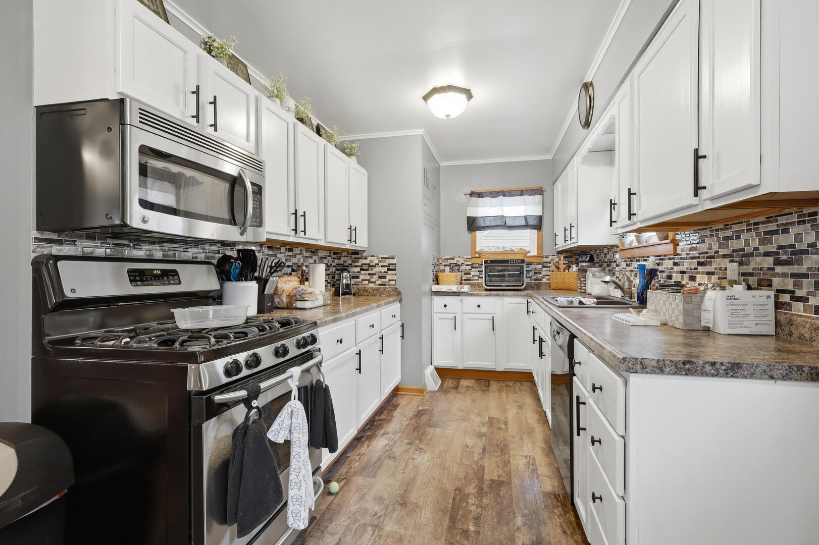 2224 41st Street Rock Island, IL 61201 - Photo 9 of 25 a kitchen with granite countertop a stove sink and cabinets