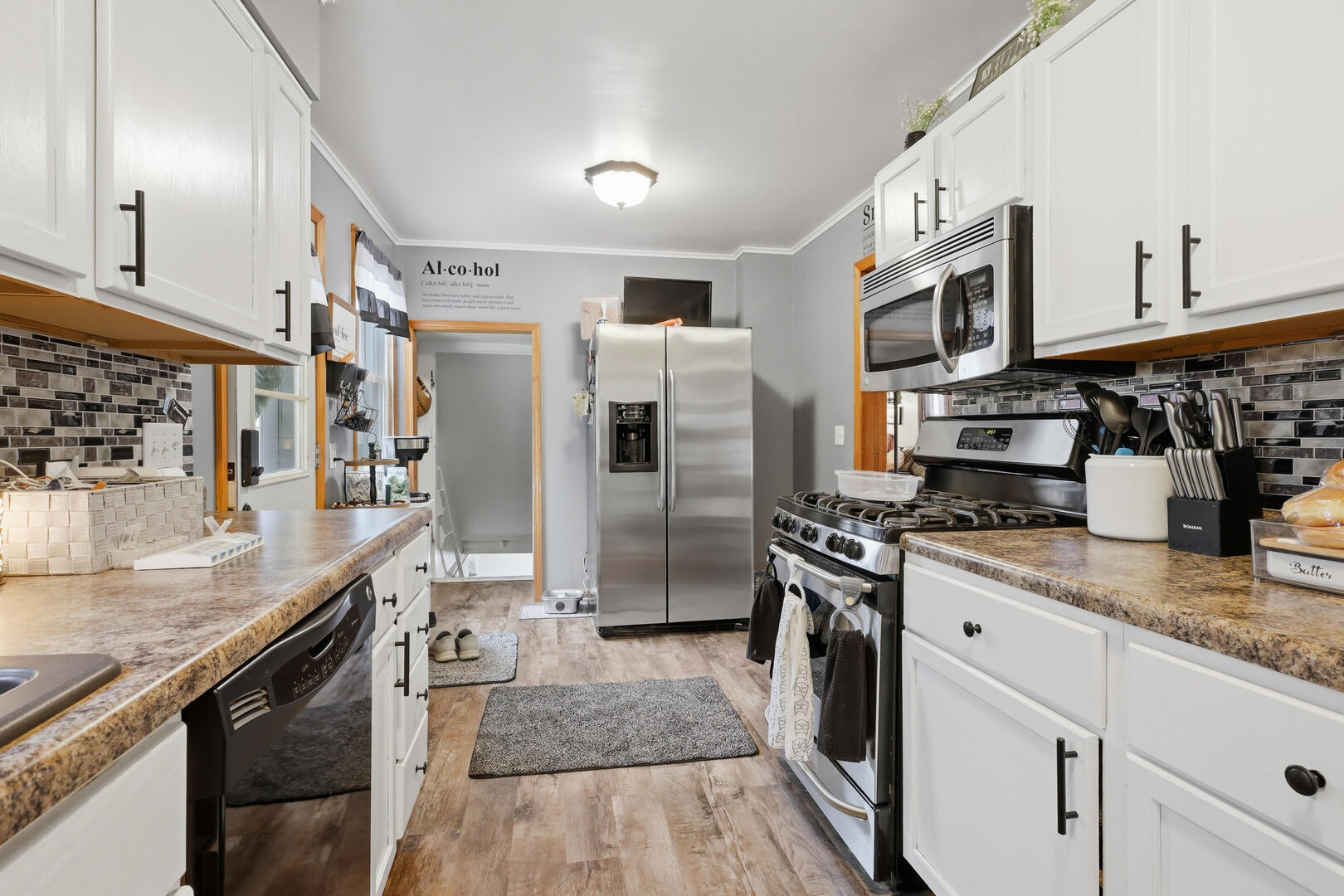 2224 41st Street Rock Island, IL 61201 - Photo 10 of 25 a kitchen with stainless steel appliances granite countertop a refrigerator a stove and a sink with wooden floors