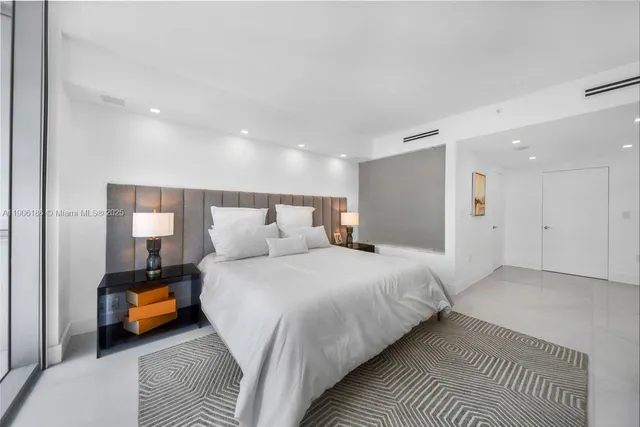 a bedroom with bed and a night stand