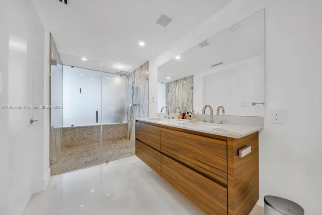 a spacious bathroom with a shower sink and mirror