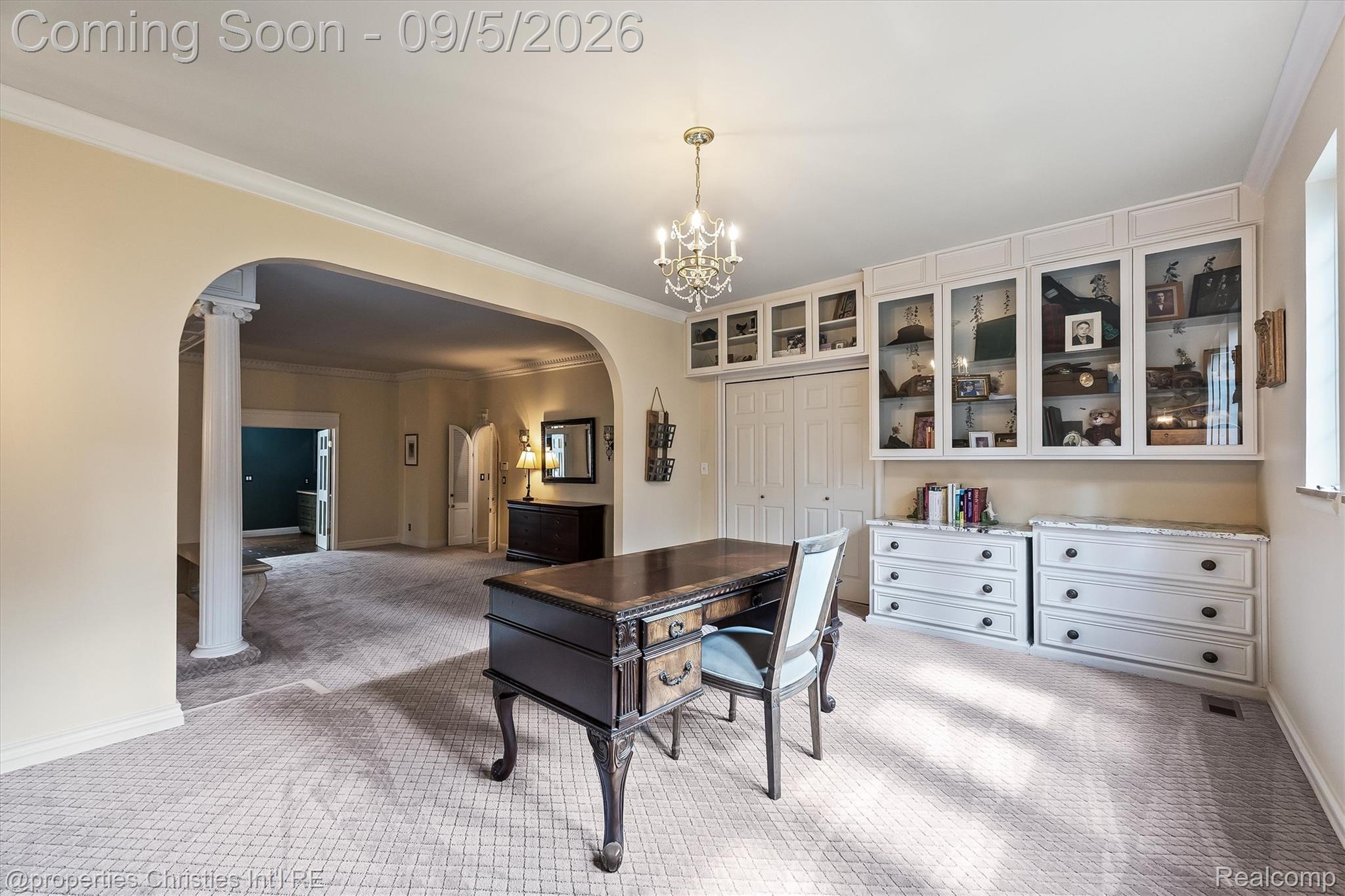1540 Mill Race Road Rochester, MI 48306 - Photo 59 of 99 Built-in cabinetry with glass-front uppers and solid lower drawers, columned archway, patterned carpeting, and crown molding