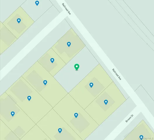 a room with a refrigerator and a dresser