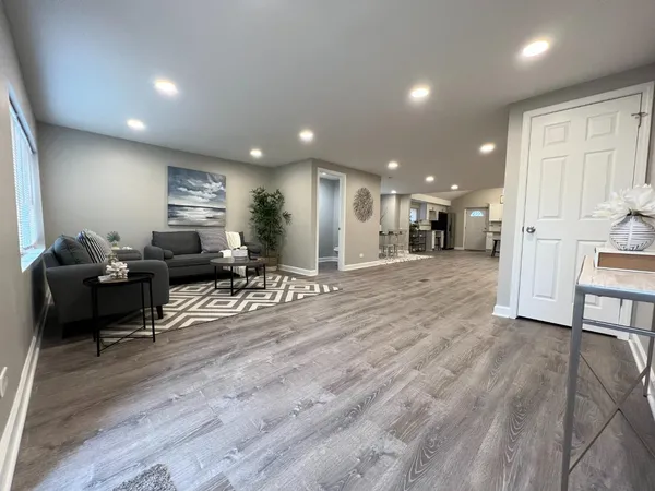 a view of a living room kitchen and a wooden floor