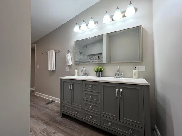 a bathroom with a double vanity sink and a mirror