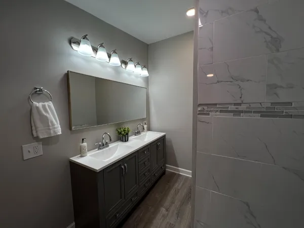 a bathroom with a sink vanity and mirror