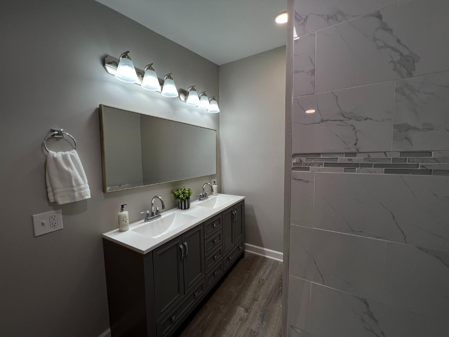 276 North Henry Street Gary, IN 46403 - Photo 17 of 34 a bathroom with a sink vanity and mirror