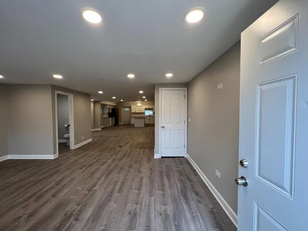 a view of hallway with wooden floor