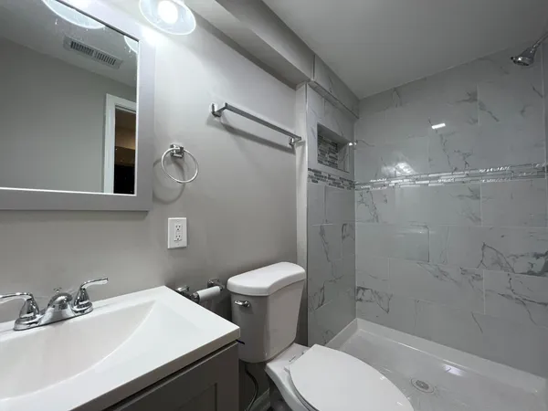 a bathroom with a sink toilet and shower
