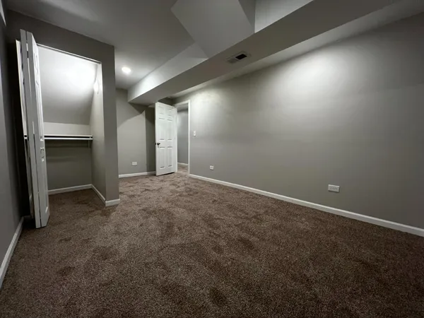 an empty room with closet and wooden walls