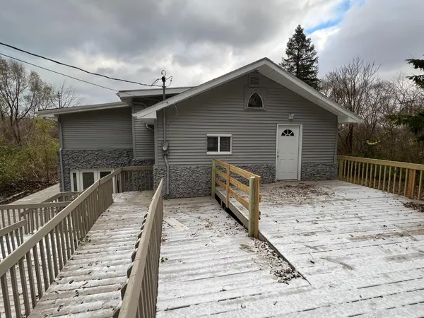 a view of a house with wooden deck