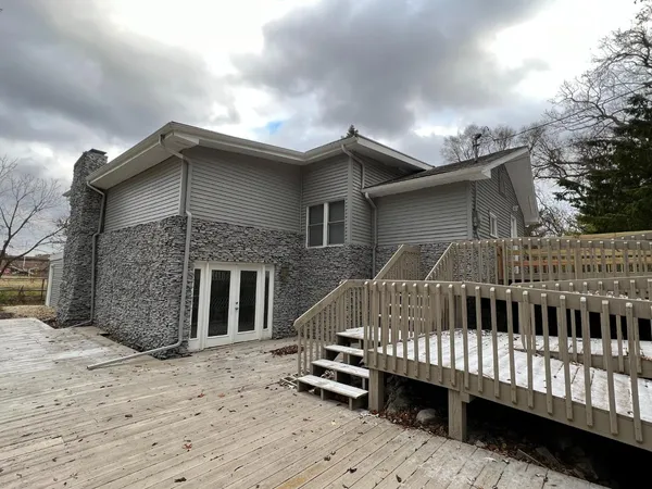 a view of a house with a wooden deck