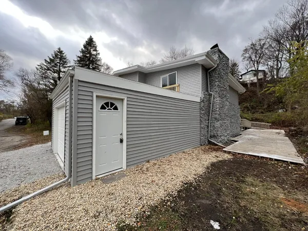 a view of a house with a yard and garage