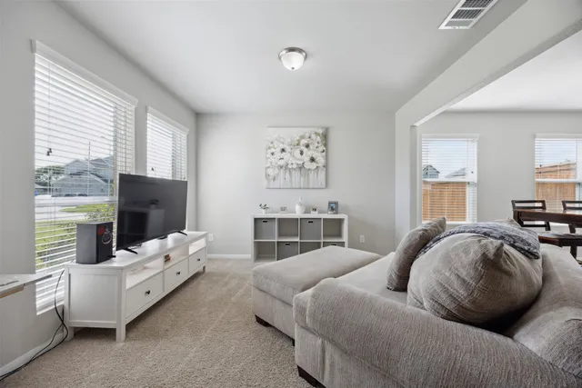 a bedroom with furniture and a flat screen tv
