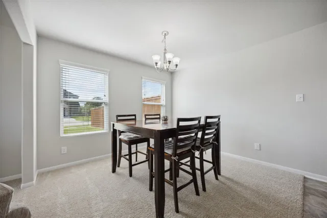 a view of a dining room with furniture window and outside view