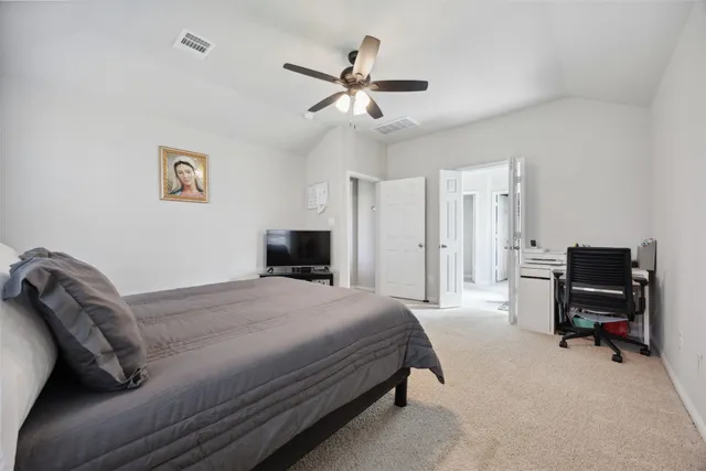 a bedroom with a bed and a desk