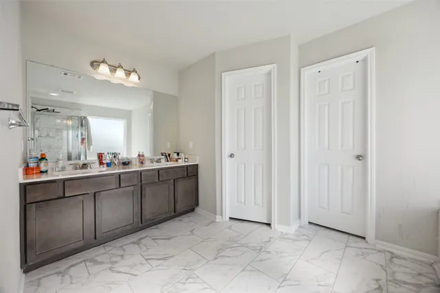 a bathroom with a sink vanity and mirror