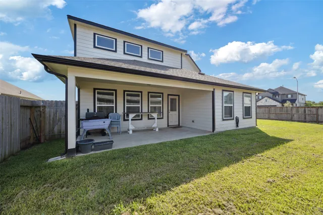 a view of a house with a yard and sitting area