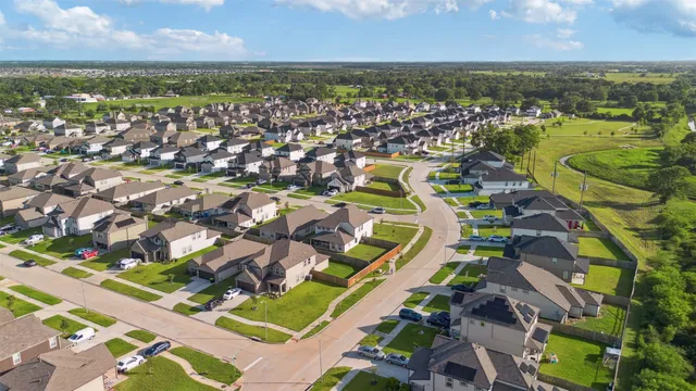 an aerial view of residential building and lake