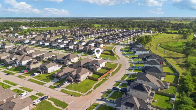an aerial view of residential houses with outdoor space