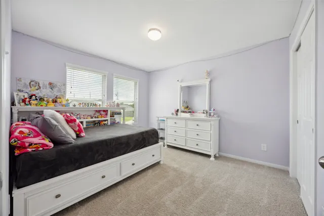 a bedroom with furniture and a window