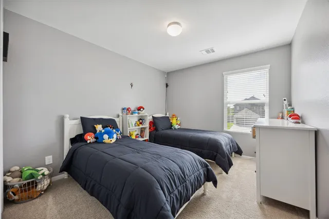 a bedroom with two beds and a window