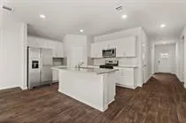 a kitchen with sink and cabinets