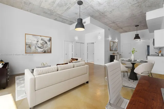 a living room with furniture a window and a chandelier