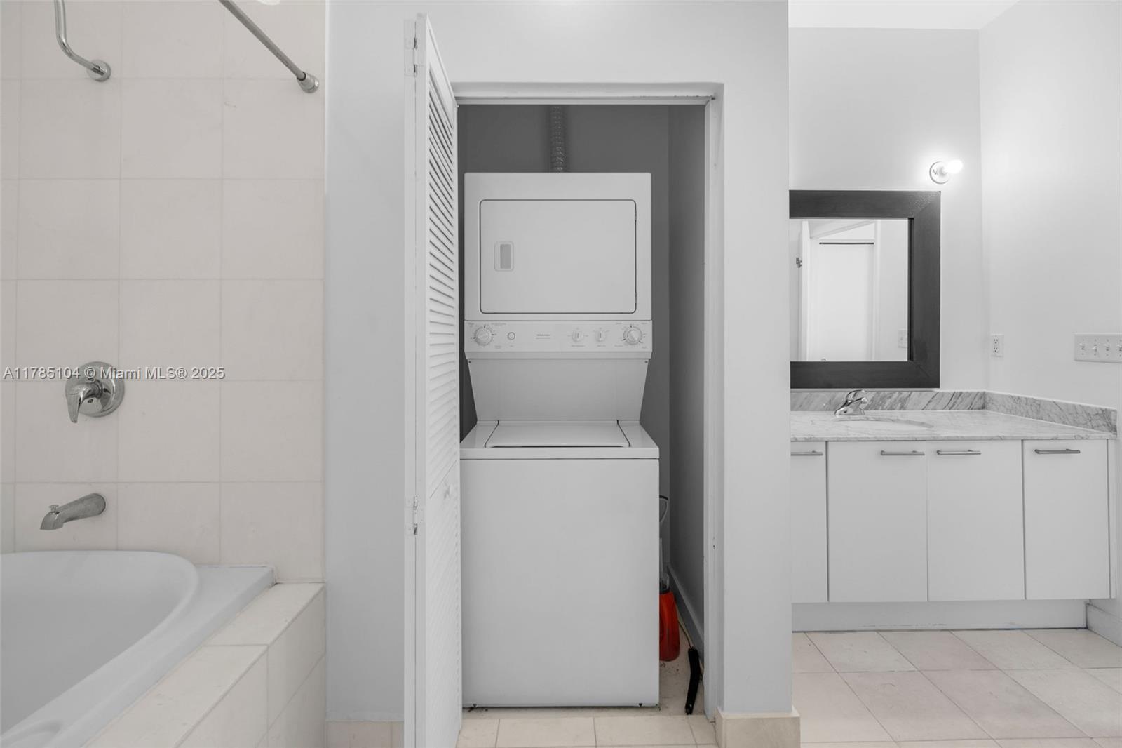 2001 Meridian Avenue, Unit 412 Miami Beach, FL 33139 - Photo 6 of 31 a bathroom with a sink and a mirror