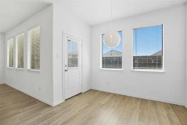 a view of a room with wooden floor and windows